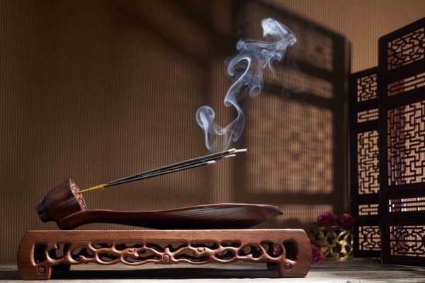 Smoke from burning incense sticks standing on lotus incense holder Smoke from burning incense sticks standing on lotus incense holder.